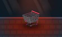 A miniature shopping cart sits on a keyboard.