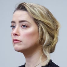 Actress Amber Heard looks solemnly ahead at the defamation trial Heard vs. Depp.