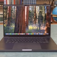 16-inch M4 Pro MacBook Pro with a library background