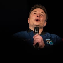 elon musk holding a microphone